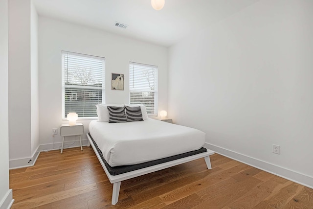 bedroom with hardwood / wood-style flooring