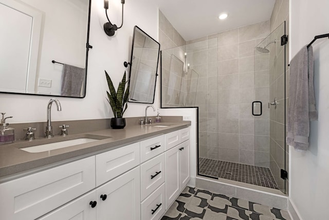 bathroom with vanity and a shower with shower door