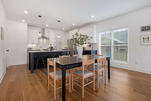 dining area with light hardwood / wood-style flooring and sink