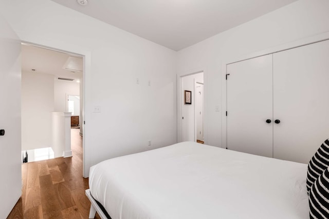 bedroom featuring wood-type flooring and a closet