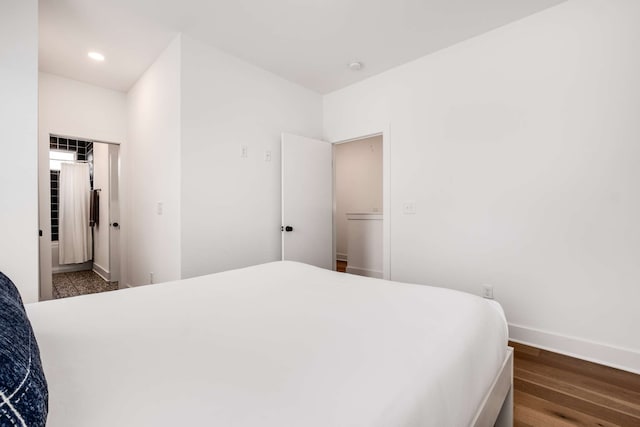 bedroom with a closet and dark hardwood / wood-style floors