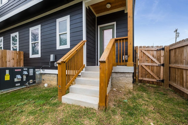 doorway to property featuring a lawn