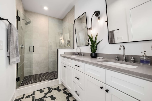 bathroom featuring tile patterned flooring, vanity, and a shower with door