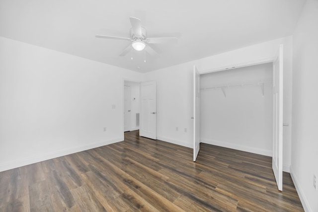 unfurnished bedroom with ceiling fan, dark hardwood / wood-style floors, and a closet