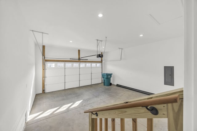 garage with a garage door opener and electric panel