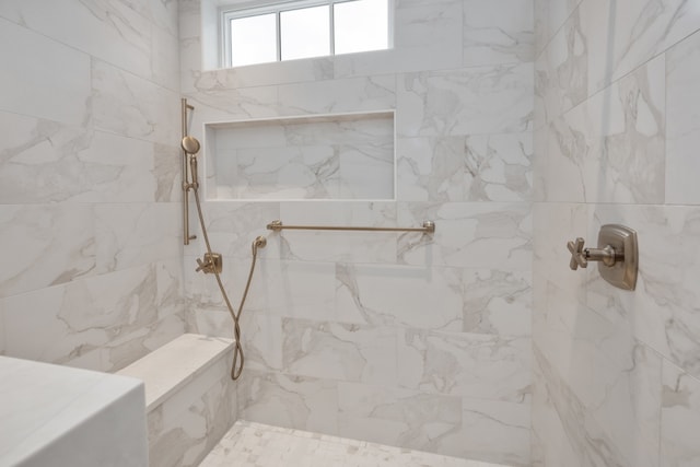 bathroom featuring tiled shower