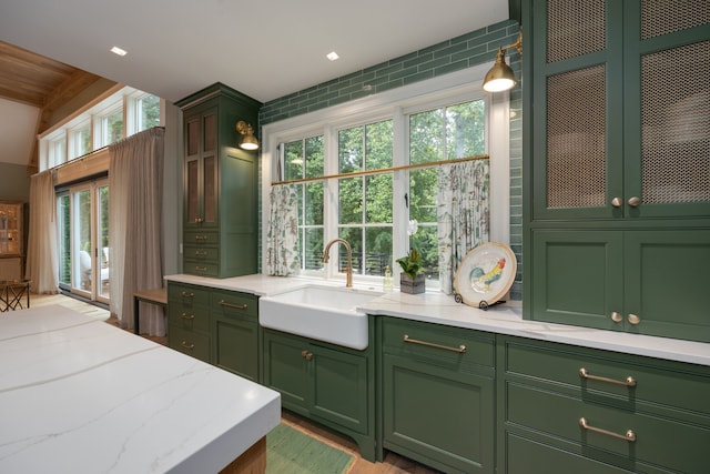 kitchen featuring green cabinets, sink, and plenty of natural light