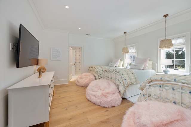 bedroom featuring light hardwood / wood-style flooring and ornamental molding