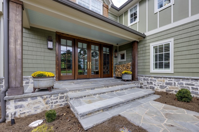 property entrance featuring french doors and a porch