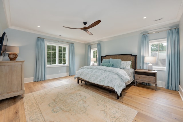 bedroom featuring light wood-type flooring, ceiling fan, and crown molding