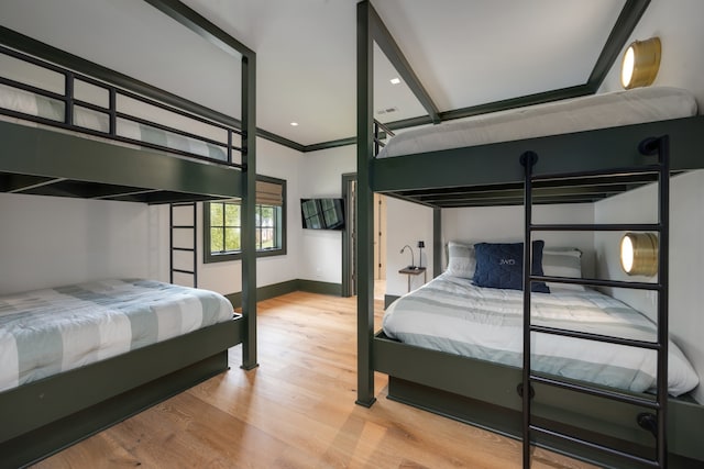 bedroom with hardwood / wood-style flooring and ornamental molding