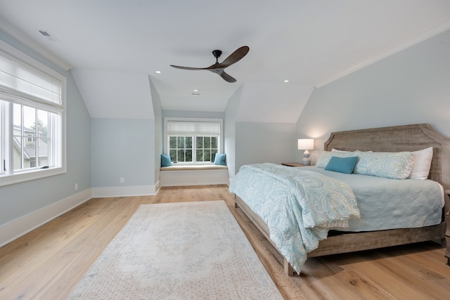 bedroom featuring light hardwood / wood-style floors, lofted ceiling, and ceiling fan