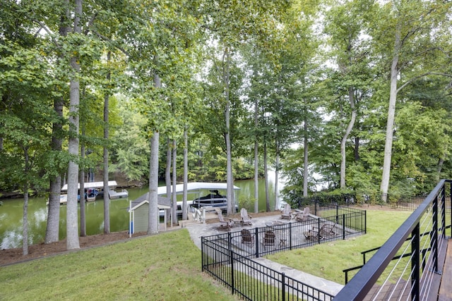 view of yard with a dock and a water view