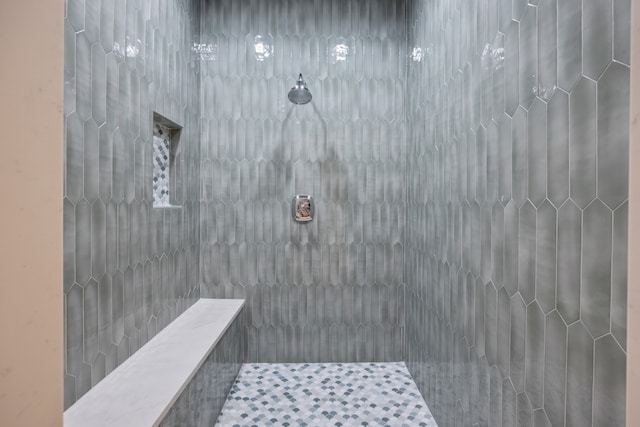 bathroom with tiled shower