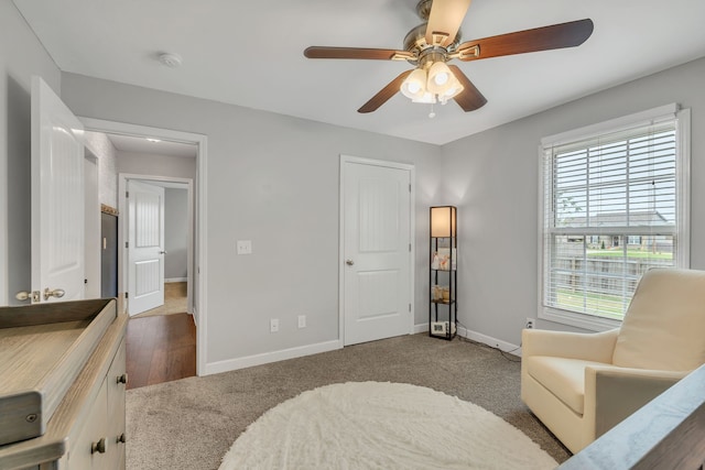 interior space featuring dark hardwood / wood-style floors, ceiling fan, and multiple windows