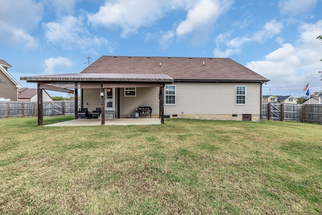 rear view of house with a lawn and a patio