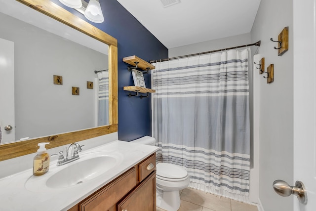 bathroom with vanity, curtained shower, tile patterned floors, and toilet