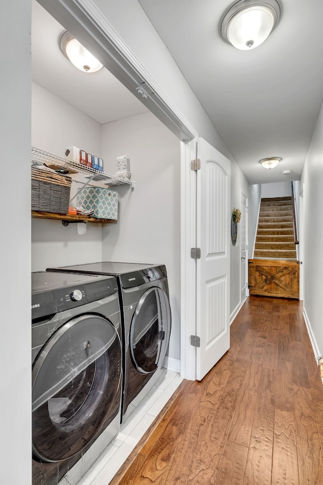 laundry area featuring washer and clothes dryer and hardwood / wood-style flooring