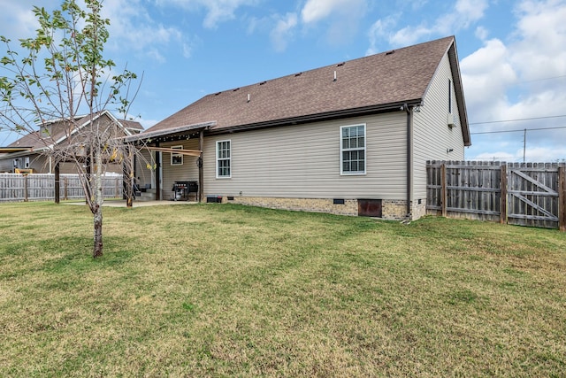 back of house with a yard and a patio