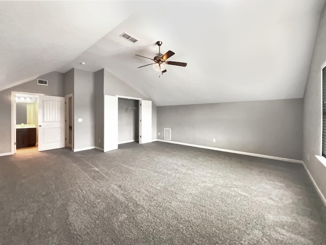 bonus room featuring ceiling fan, dark colored carpet, and vaulted ceiling