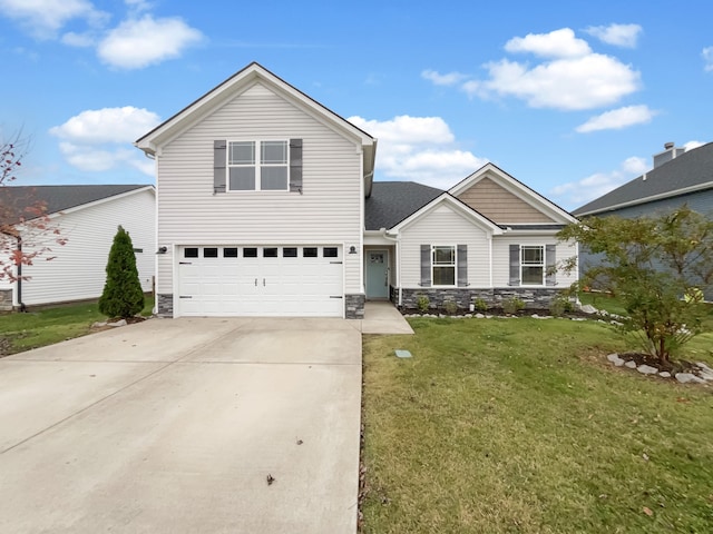 view of property with a garage and a front lawn