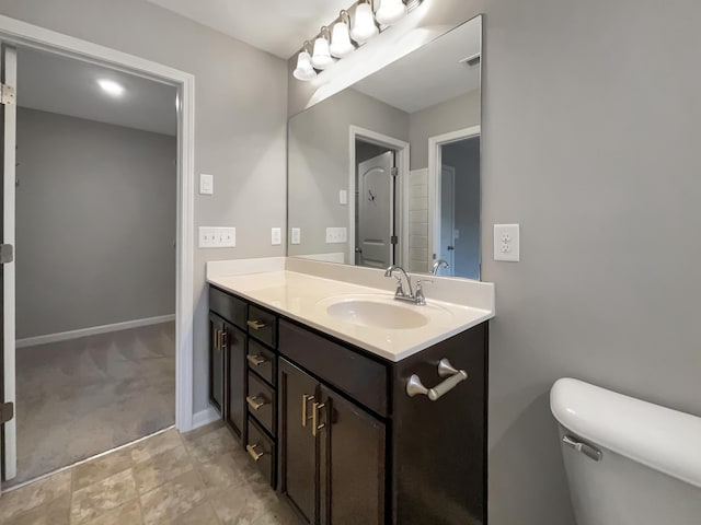 bathroom featuring vanity and toilet