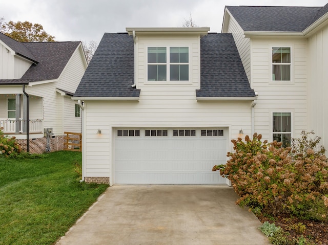 view of front of house featuring a garage and a front lawn