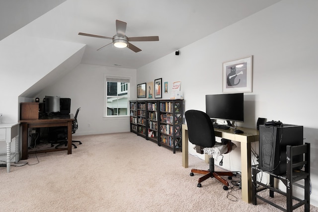 carpeted office space with ceiling fan and vaulted ceiling