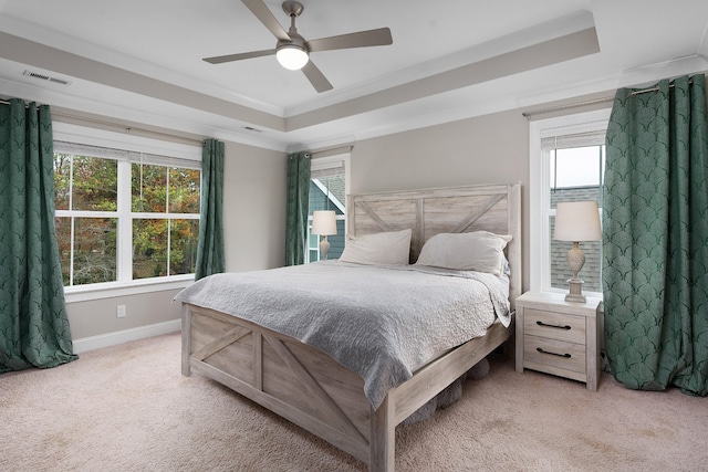 bedroom with ceiling fan, multiple windows, and light colored carpet