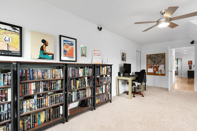 home office featuring light carpet and ceiling fan