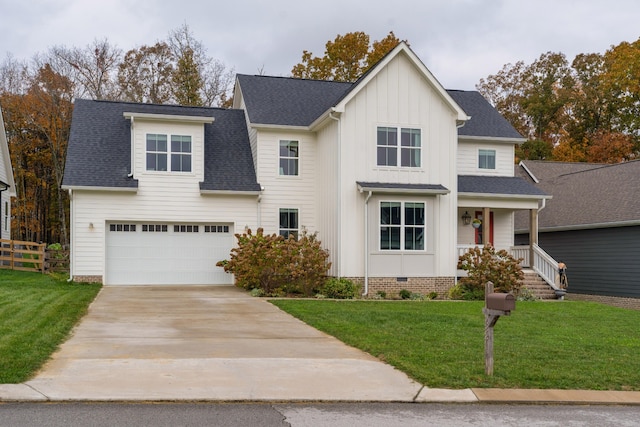 view of front of home featuring a garage, a front yard, and covered porch