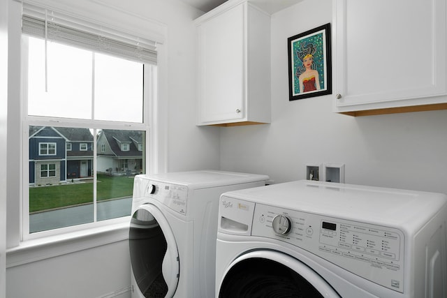 washroom featuring cabinets and independent washer and dryer