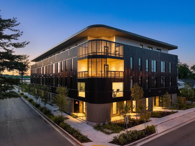 view of outdoor building at dusk