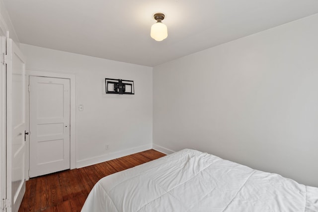 bedroom featuring a closet and dark hardwood / wood-style floors