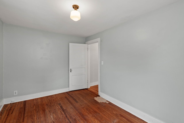 empty room with hardwood / wood-style flooring