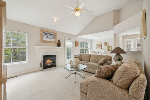 living room featuring light carpet, vaulted ceiling, and ceiling fan