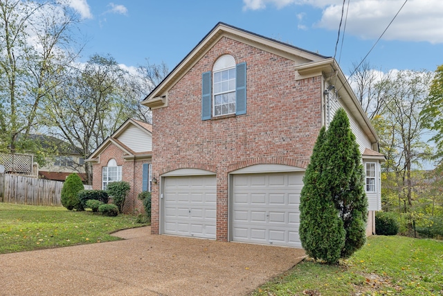 view of front of home featuring a garage and a front lawn