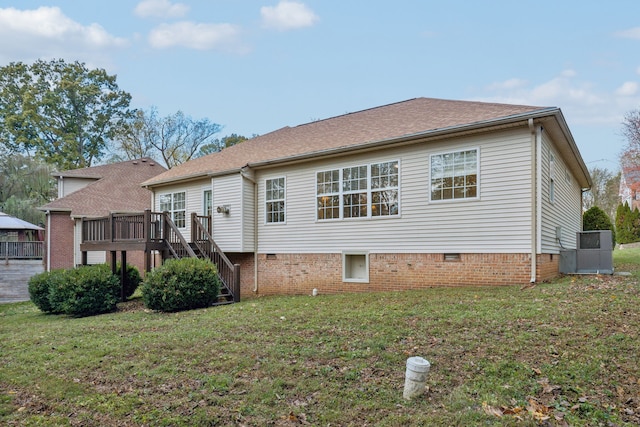 rear view of house featuring a yard and a wooden deck