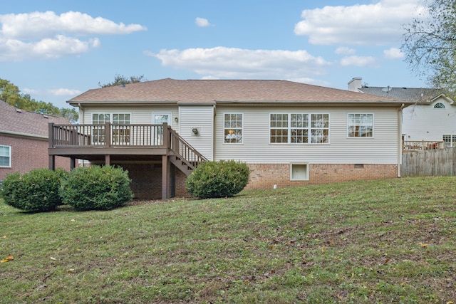 rear view of house with a lawn and a deck