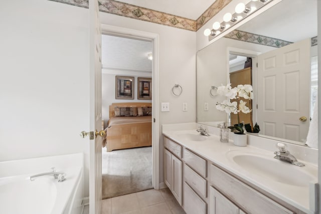 bathroom featuring a bathing tub, tile patterned flooring, and vanity