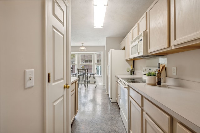 kitchen featuring light brown cabinets, white appliances, and a textured ceiling