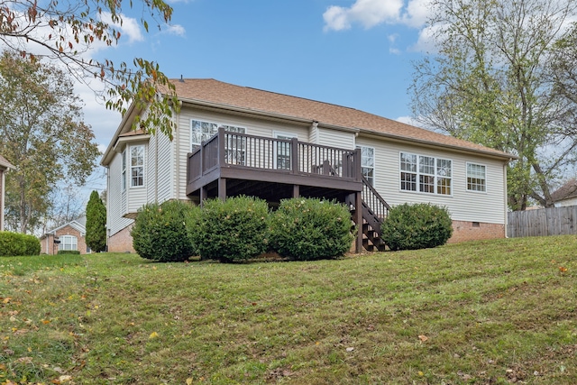 rear view of property with a yard and a wooden deck