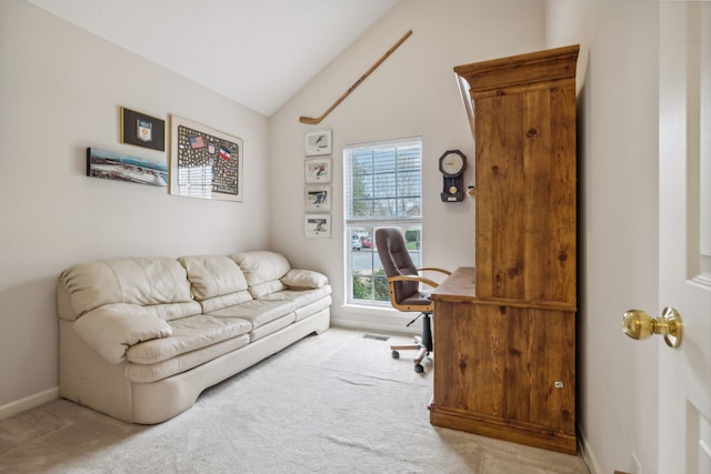 carpeted home office with lofted ceiling