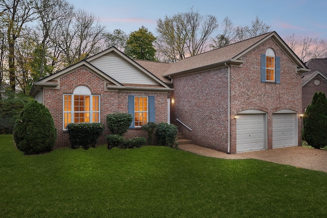 front of property featuring a garage and a lawn