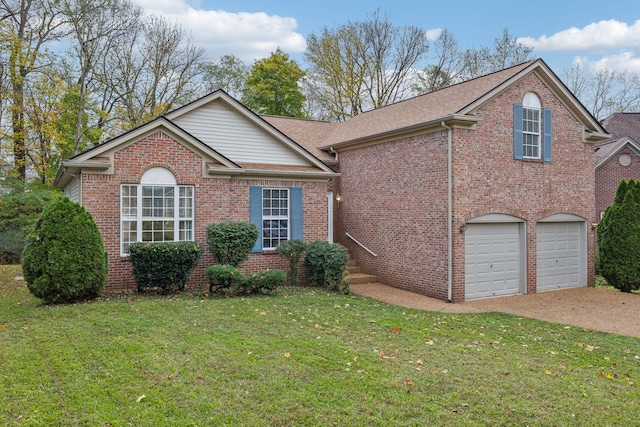 view of property with a front yard and a garage