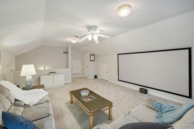 carpeted cinema room featuring ceiling fan, lofted ceiling, and a textured ceiling