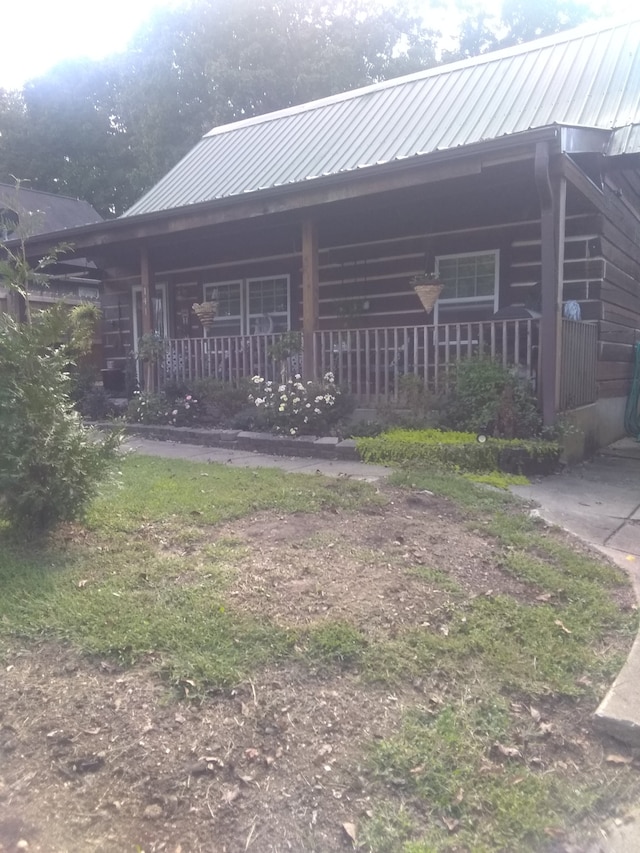 back of property with covered porch