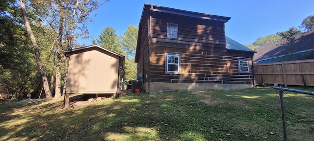 view of home's exterior with a yard and cooling unit