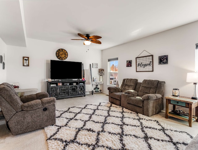 carpeted living room with ceiling fan