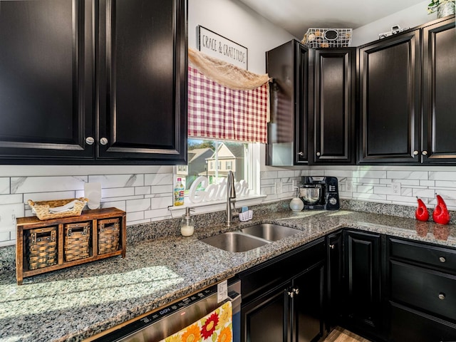 kitchen featuring stone counters, sink, and tasteful backsplash